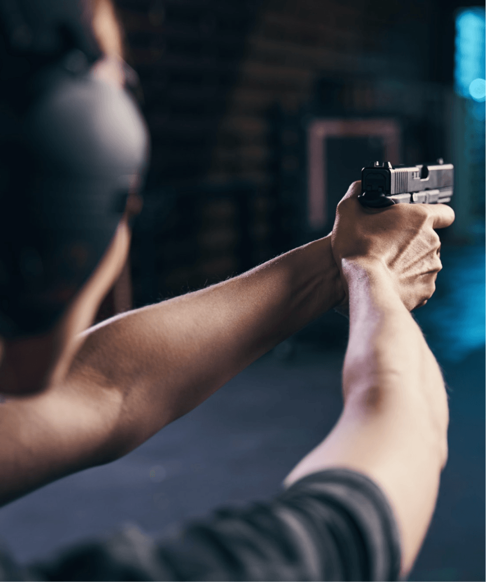 Shooter aiming a handgun at the range